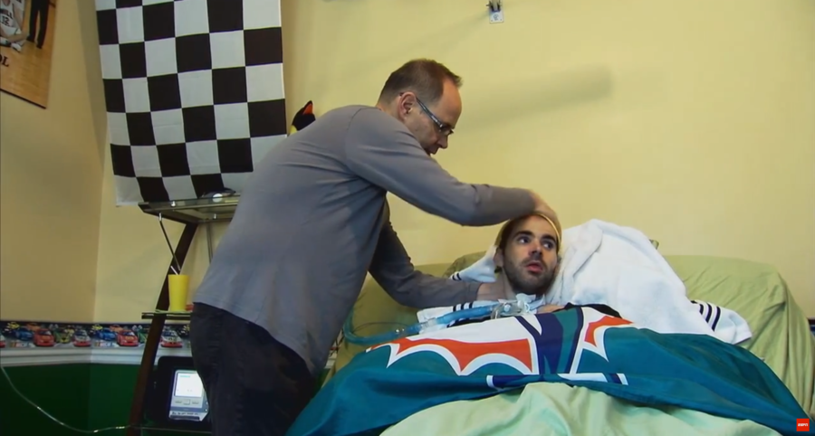 Ernie Johnson tends to his son Michael in a scene from E:60's profile of the TNT host.