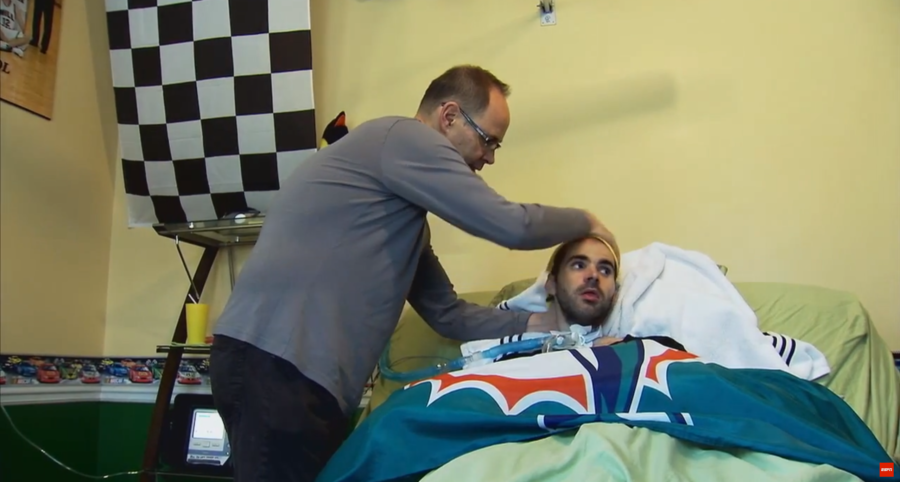 Ernie Johnson tends to his son Michael in a scene from E:60's profile of the TNT host. 