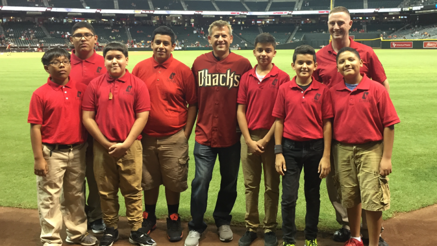 "ESPN Sport Science" host John Brenkus (wearing jersey) meets members of Phoenix's Loyola Academy when Brenkus visited Arizona on Oct. 2 to throw out the first pitch at a Diamondbacks' game. (Photo courtesy of John Brenkus)