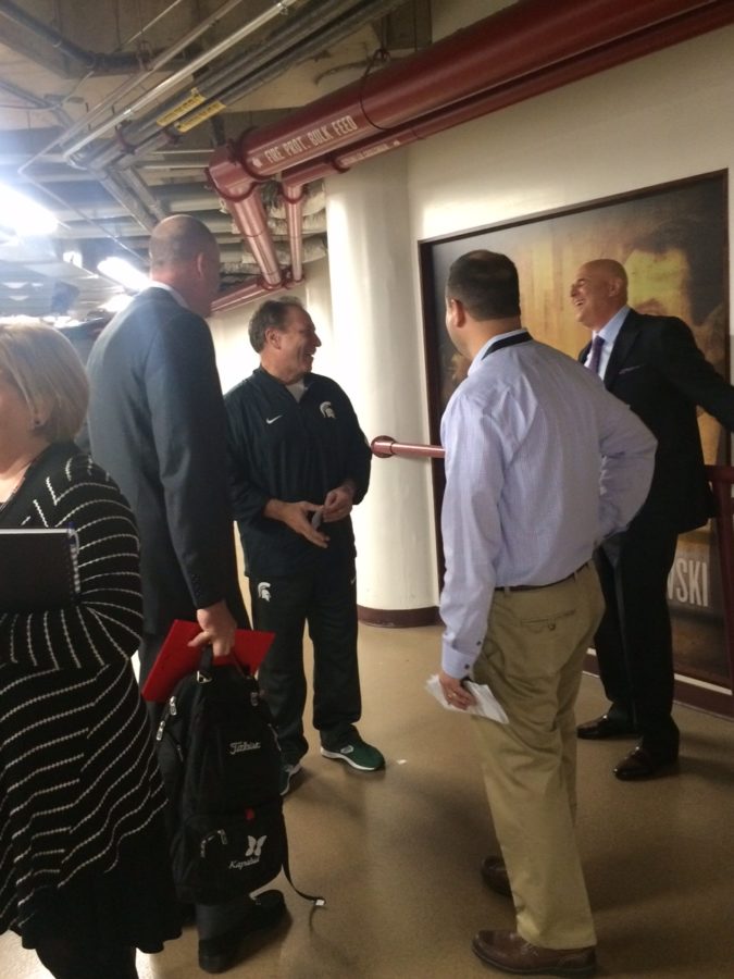 Jay Bilas (far left), Michigan State basketball coach Tom Izzo (second from left) and Seth Greenberg (far right) meet in the United Center hallways. (Derek Volner/ESPN)