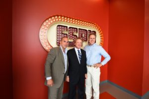 (L-R) Jay Rothman, MNF analyst Jon Gruden and Chip Dean stand in front of the ESPN sign in DC-2. (Joe Faraoni/ESPN Images)
