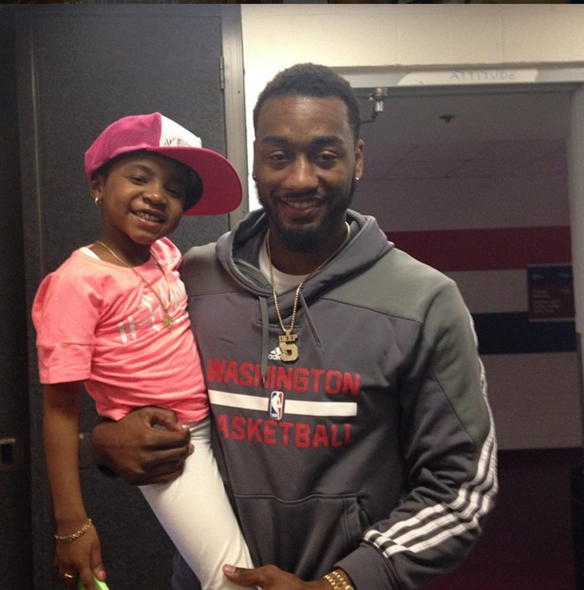 John Wall holding Miyah wearing Wizards hat. (Courtesy Susan Ansman)