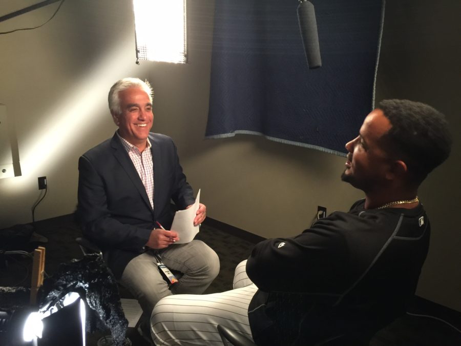 Pedro Gomez (left) interviews White Sox slugger Jose Abreu who defected from Cuba in 2013.  (Toby Hershkowitz/ESPN)