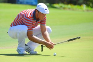 Bryson DeChambeau lines up a putt. 