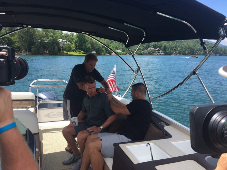 Marty Smith gets freed from fishing hooks by Nick Saban and Tim Tebow.(Jonathan Whyley/ESPN)