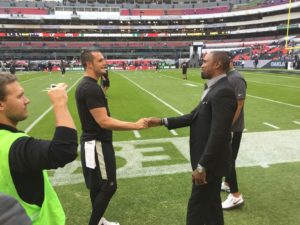 At a Monday Night Football game in Mexico City in December, Woodson (R) reunited with former Oakland Raiders teammate Derek Carr. (Bill Hofheimer/ESPN)