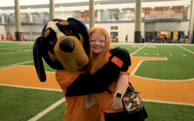 U of Tennessee’s Smokey hugs Wish Kid Bailey